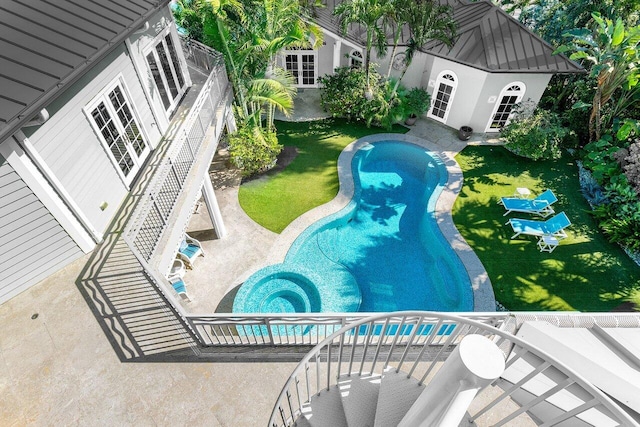 view of pool with a storage structure, a lawn, and an outbuilding