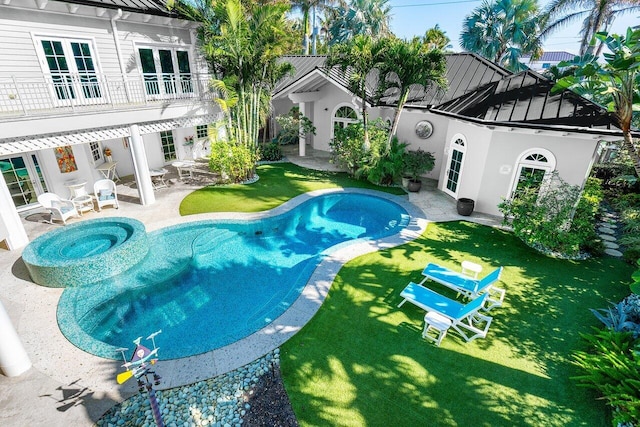 view of pool featuring a patio area and a yard