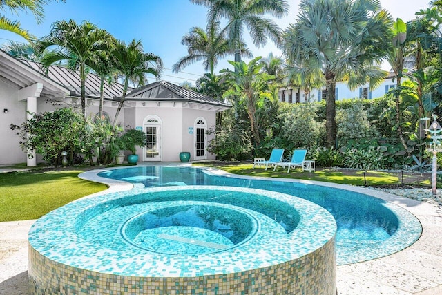 view of pool with a yard, an outdoor structure, and a pool with connected hot tub