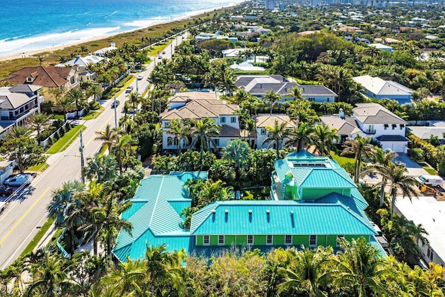 birds eye view of property featuring a beach view, a water view, and a residential view