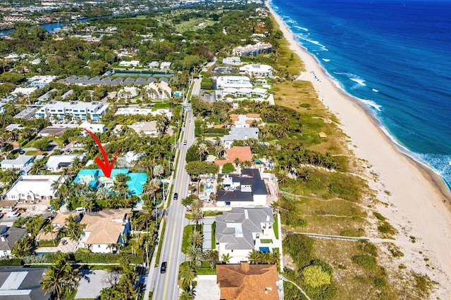 birds eye view of property featuring a residential view, a water view, and a beach view