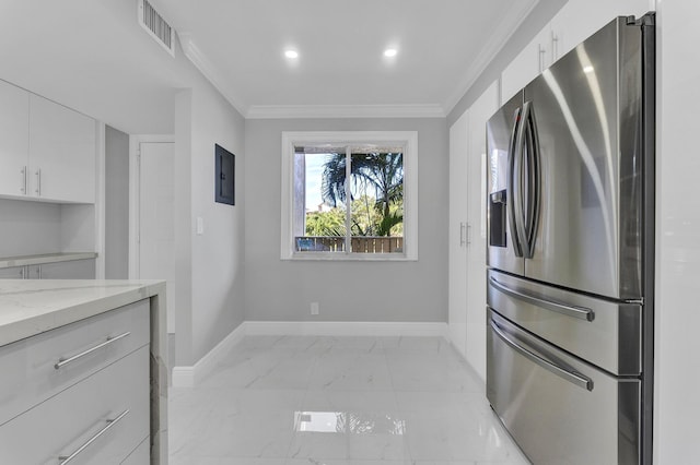 kitchen with white cabinetry, ornamental molding, stainless steel fridge with ice dispenser, and light stone counters