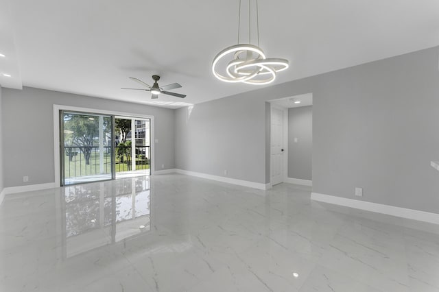 unfurnished room with ceiling fan with notable chandelier