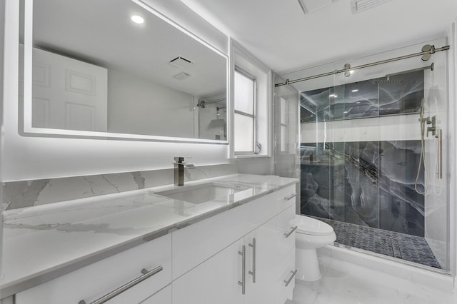 bathroom featuring vanity, an enclosed shower, and toilet