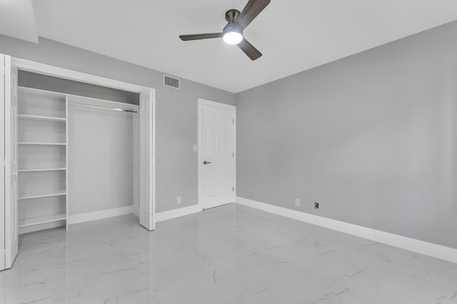 unfurnished bedroom with ceiling fan and a closet