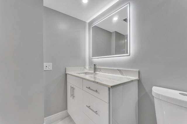 bathroom with vanity and toilet