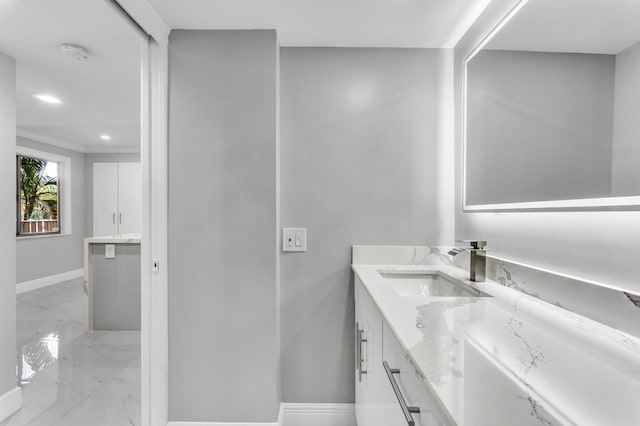 bathroom with vanity and crown molding