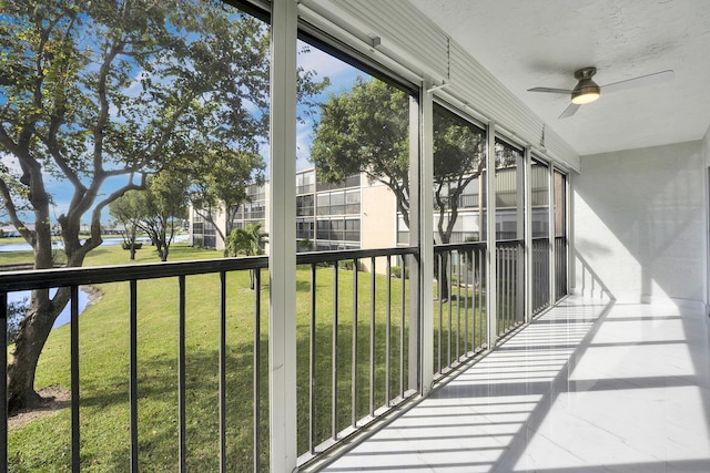 unfurnished sunroom featuring ceiling fan