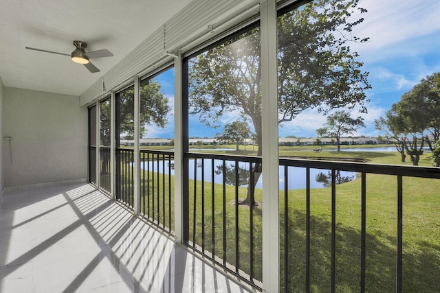 unfurnished sunroom featuring a water view