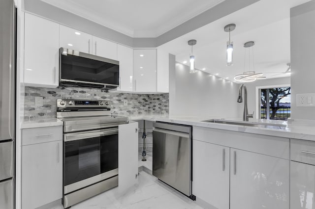 kitchen featuring sink, crown molding, appliances with stainless steel finishes, hanging light fixtures, and white cabinets