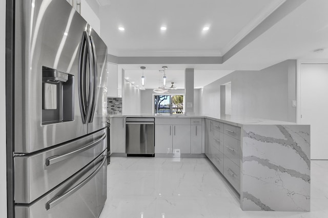 kitchen with gray cabinets, appliances with stainless steel finishes, decorative light fixtures, kitchen peninsula, and crown molding