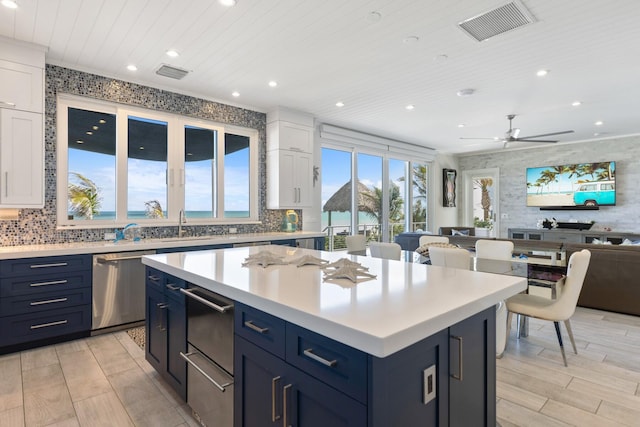 kitchen with dishwasher, a warming drawer, wood ceiling, and visible vents