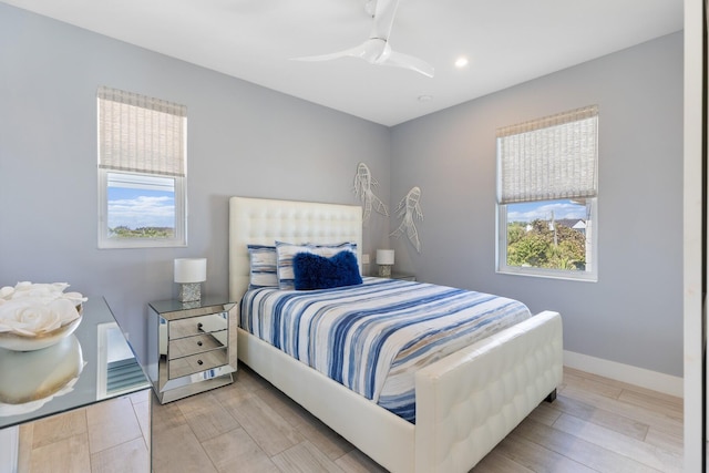 bedroom with wood finish floors, baseboards, and ceiling fan