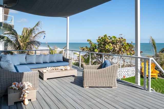 wooden terrace with a water view and an outdoor hangout area