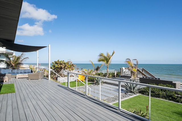 wooden deck with a lawn, a water view, and an outdoor hangout area