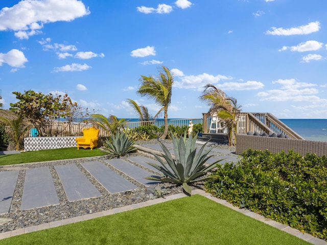 view of yard featuring fence and a water view