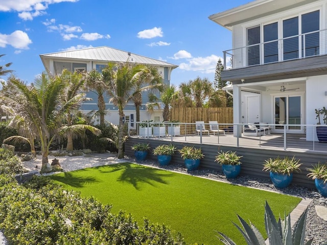 view of yard with a deck and fence