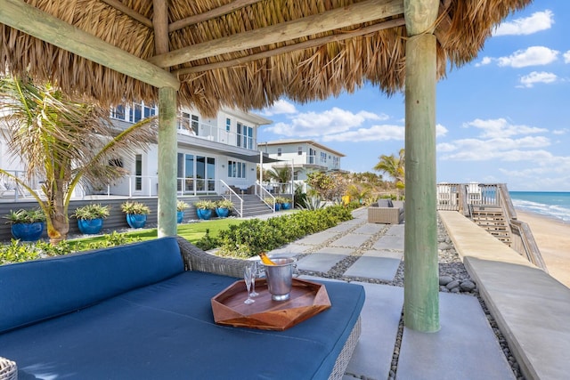 view of community featuring a gazebo, stairway, and a water view