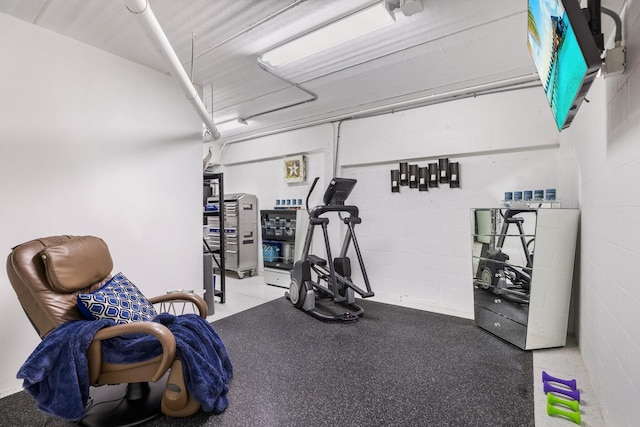 workout room featuring concrete block wall