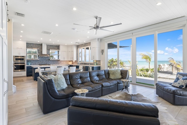 living room featuring visible vents and recessed lighting