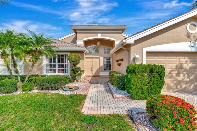 doorway to property with a garage