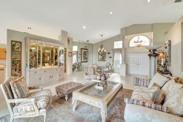 living room featuring high vaulted ceiling, light tile patterned floors, and a notable chandelier