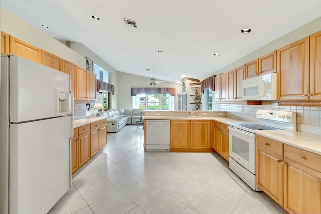 kitchen with lofted ceiling, sink, decorative backsplash, kitchen peninsula, and white appliances