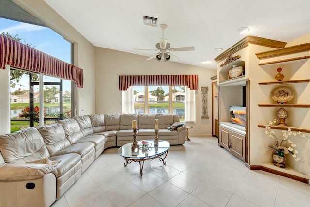 tiled living room with ceiling fan, a healthy amount of sunlight, and vaulted ceiling