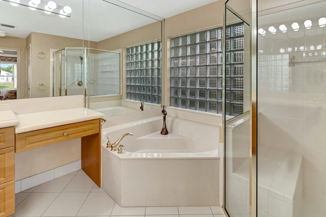 bathroom with independent shower and bath, vanity, and tile patterned flooring