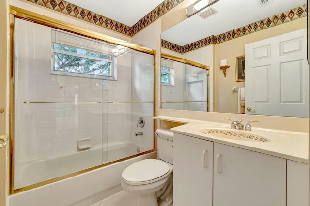 full bathroom featuring bath / shower combo with glass door, vanity, and toilet