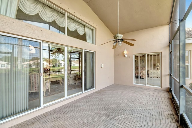 unfurnished sunroom featuring ceiling fan