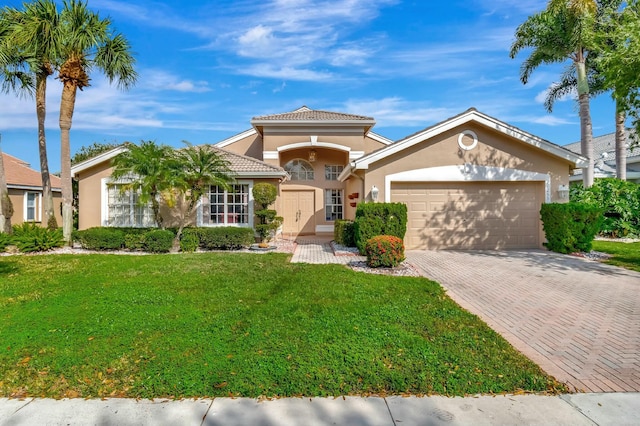 mediterranean / spanish house featuring a garage and a front lawn