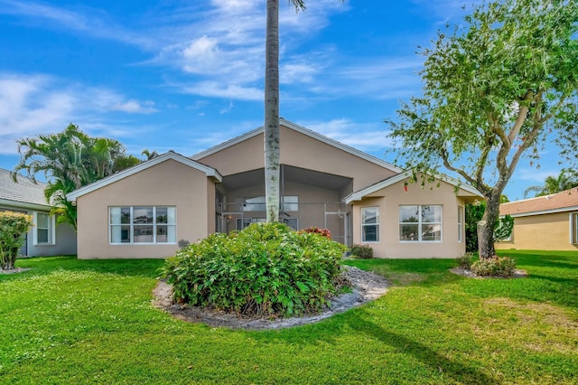 back of property featuring a lawn