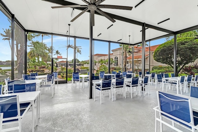 unfurnished sunroom featuring ceiling fan