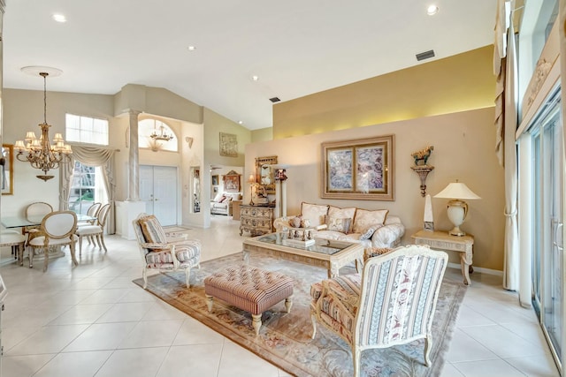 living room with high vaulted ceiling, a chandelier, and light tile patterned flooring