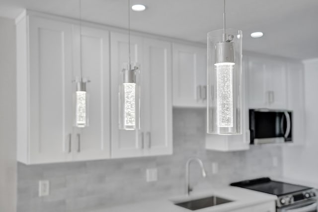 kitchen with white cabinetry, sink, and electric stove