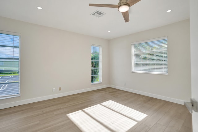 unfurnished room with ceiling fan and light wood-type flooring