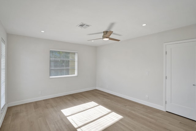 empty room featuring ceiling fan and light hardwood / wood-style floors