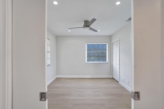 spare room with ceiling fan and light hardwood / wood-style flooring