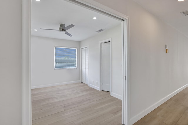 corridor with light hardwood / wood-style flooring