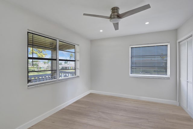 empty room with light hardwood / wood-style flooring and ceiling fan