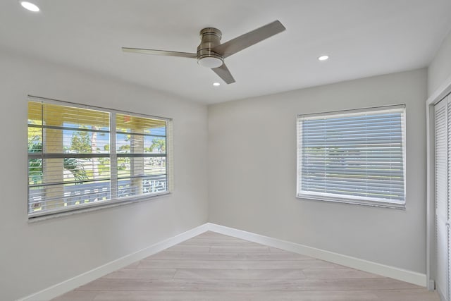 unfurnished room with ceiling fan and light hardwood / wood-style floors