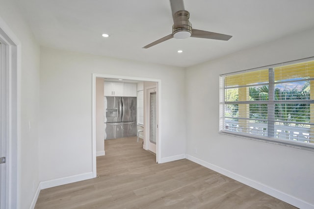 empty room featuring ceiling fan and light hardwood / wood-style floors