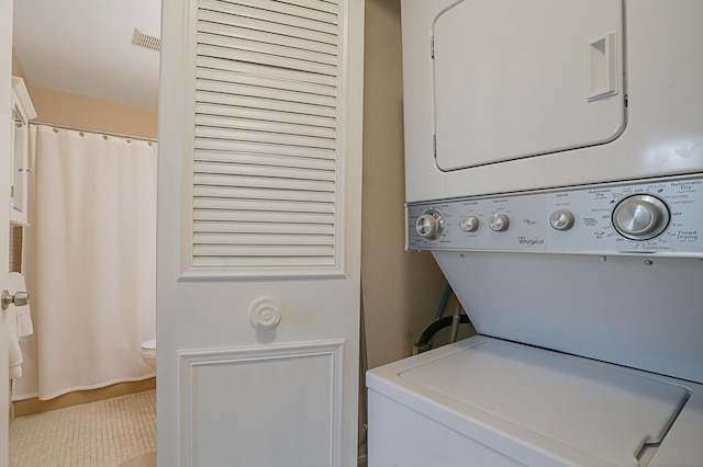 laundry room featuring stacked washer and dryer