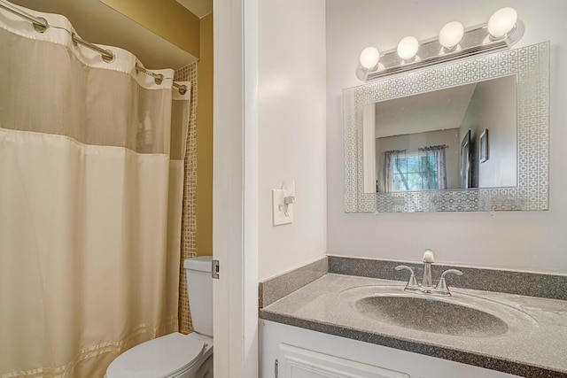 bathroom featuring vanity, a shower with curtain, and toilet