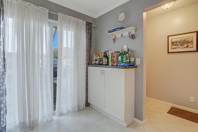 interior space featuring crown molding and white cabinets