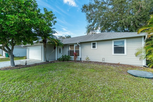 ranch-style home with a garage and a front lawn