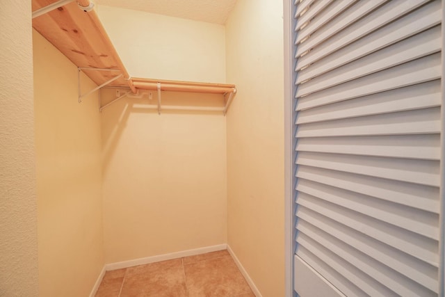 walk in closet featuring light tile patterned floors