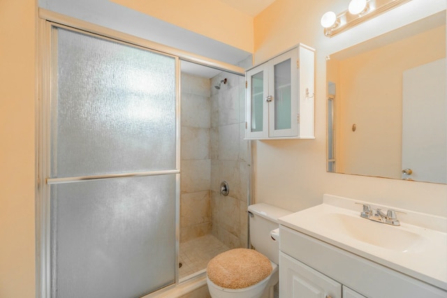 bathroom with vanity, toilet, and an enclosed shower