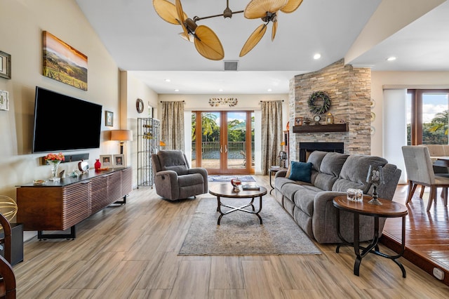 living room featuring french doors, lofted ceiling, and plenty of natural light